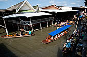 Thailand, Locals sell fruits, food and products at Damnoen Saduak floating market near Bangkok 